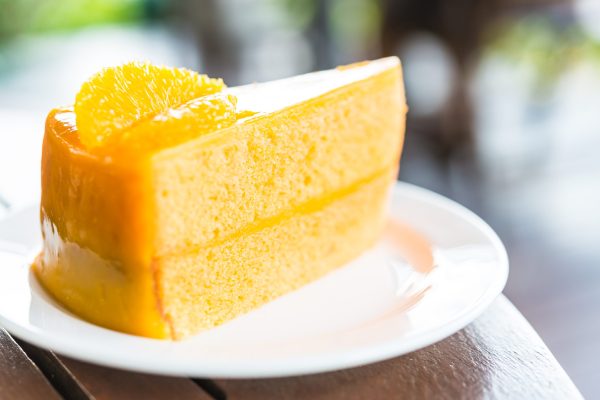 Orange cakes in white plate on wooden tables - selective focus shot