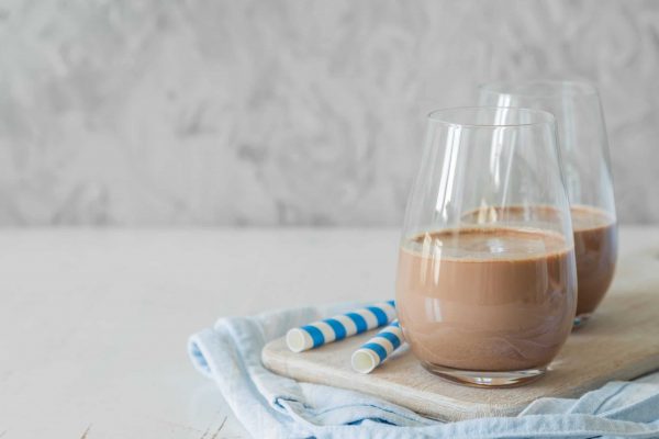 Cold chocolate milk in glasses, copy space