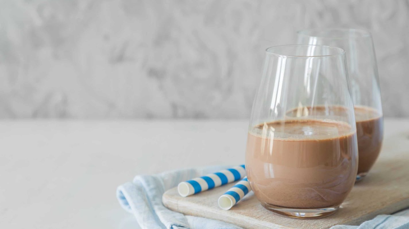 Cold chocolate milk in glasses, copy space