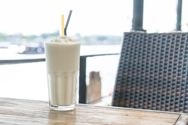 white malt milkshake on wood table