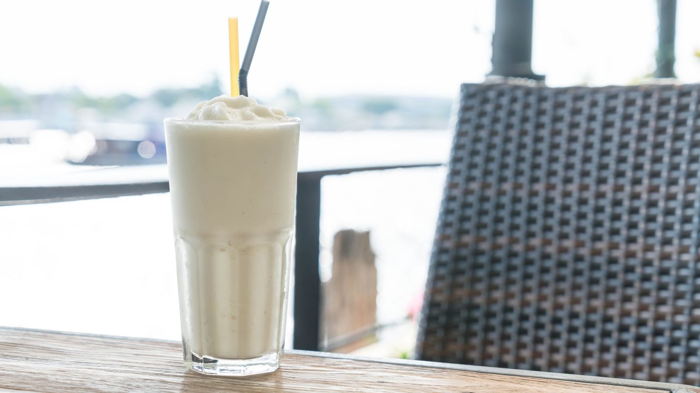 white malt milkshake on wood table